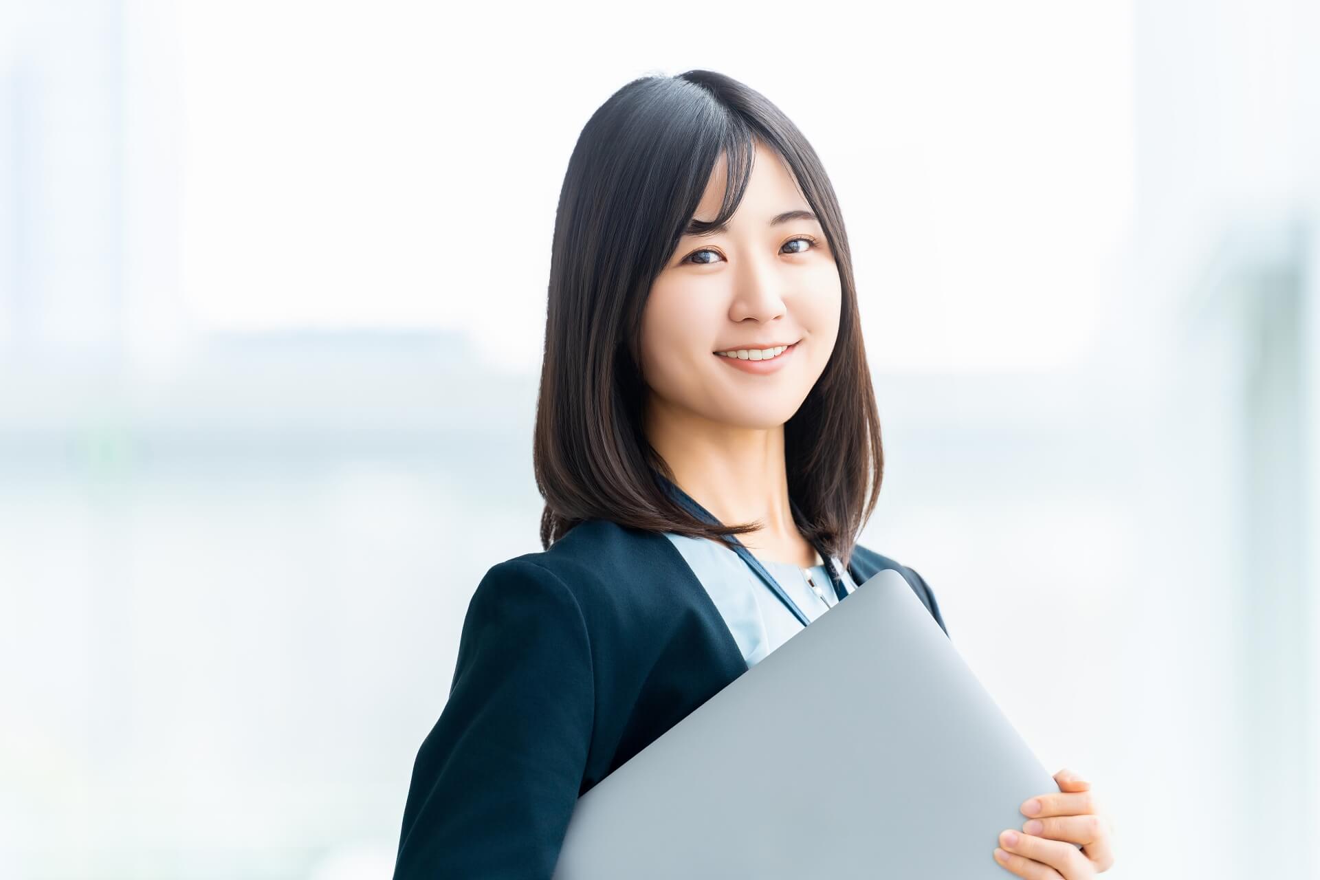 ノートPCを抱える笑顔の女性、OL、ノートパソコン