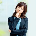 小首をかしげる困った顔のスーツ姿の女性、OL、困る